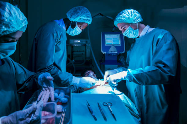 Surgeon doctors are performing heart surgery operation for patient